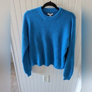 Slub knit blue crew neck sweater.